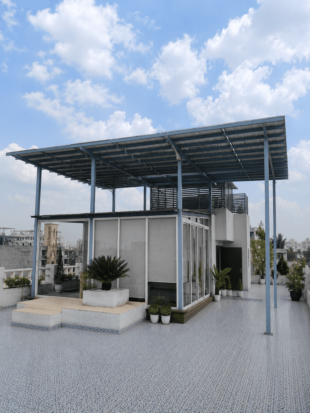 Rooftop terrace with a solar panel canopy providing shaded outdoor space